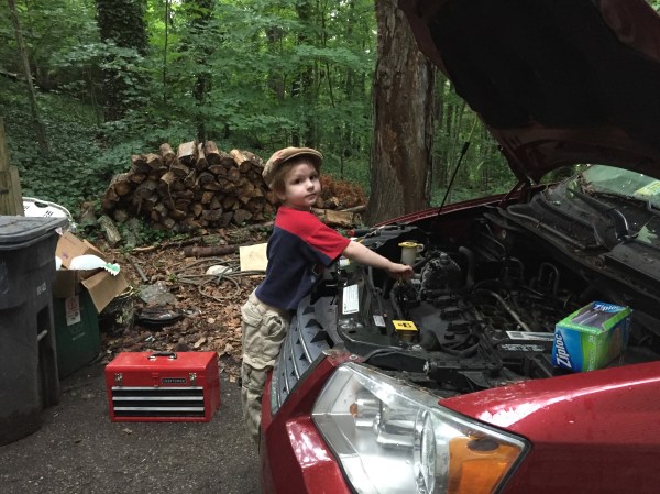Guy Works On the Car With Dad